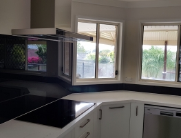 Taubmans Black Jack coloured toughened glass splashback by Graphic Glass Services