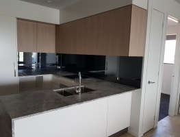 Grey Tint Toughened Mirror Splashback by Graphic Glass Services Qld