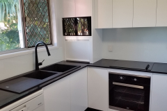 Stunning White Colourback Glass Kitchen Splashback by Graphic Glass Services Qld paired with black accessories