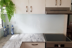 White Splashback with a Speckled Granite Benchtop by Graphic Glass Services 2