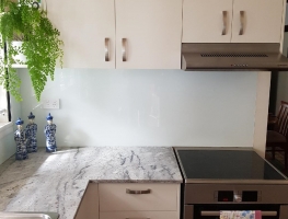 White Splashback with a Speckled Granite Benchtop by Graphic Glass Services 2