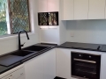 Stunning White Colourback Glass Kitchen Splashback by Graphic Glass Services Qld paired with black accessories
